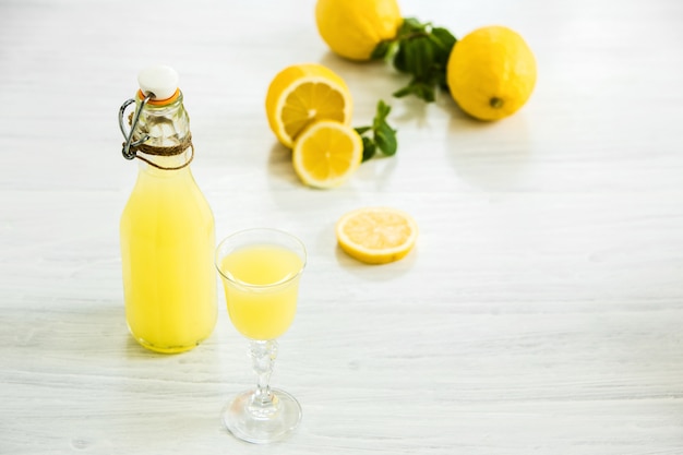 Italian traditional liqueur limoncello with lemon