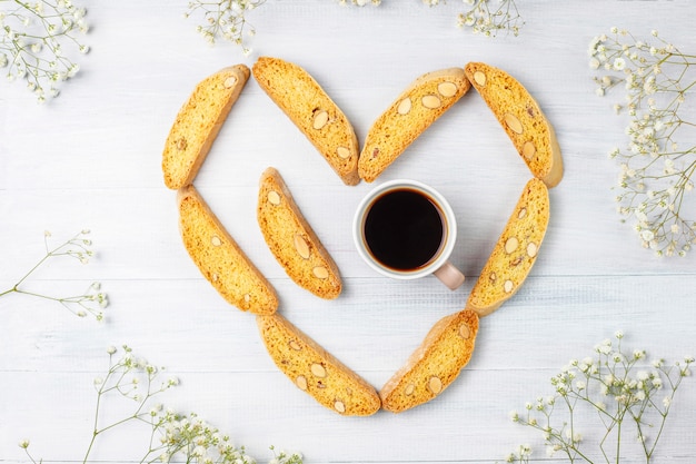 Free photo italian tuscan traditional cookies cantuccini with almonds, a cup of coffee on light