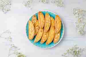 Free photo italian tuscan traditional cookies cantuccini with almonds, a cup of coffee on light