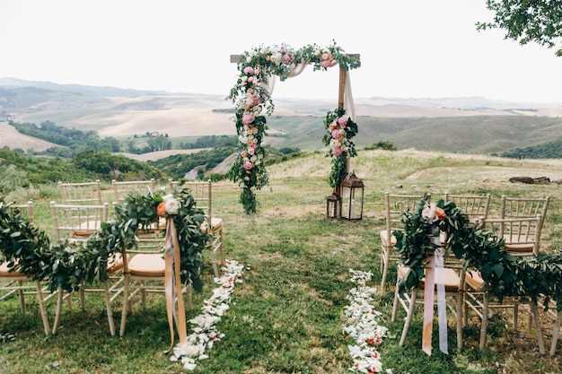 Italian wedding decoration. Green eucalyptus, oranges and pink f