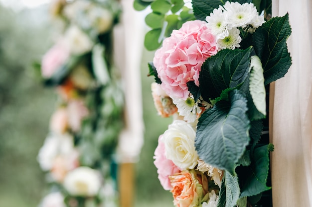 Italian wedding decoration. Green eucalyptus, oranges and pink f