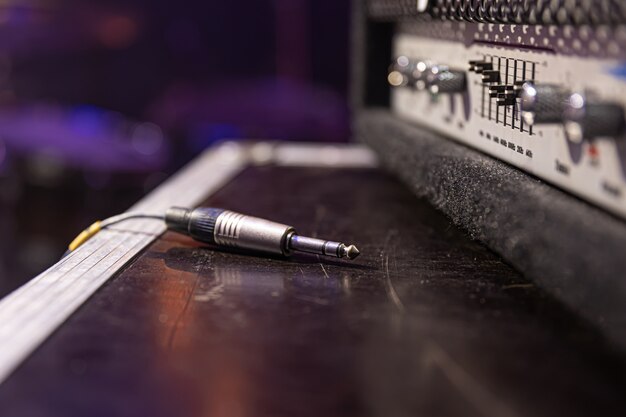 Jack audio connector being plugged into a socket on an audio device for music, audio.