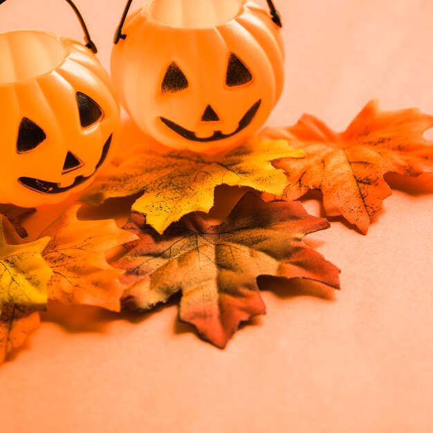 Jack-o-lantern baskets on leaves