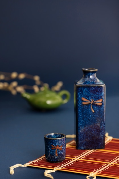 Free photo japanese bottle and cup arrangement