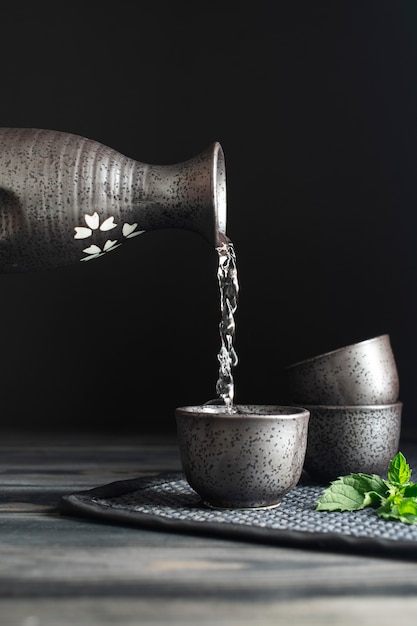 Free photo japanese bottle pouring into cup