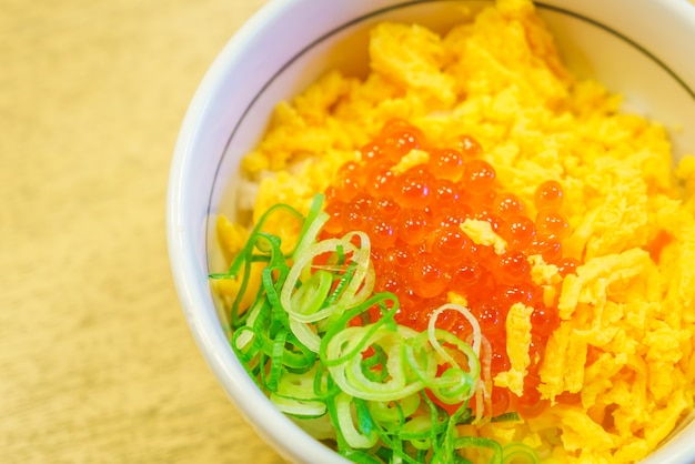 Free photo japanese food style salmon eggs on top of rice bowl