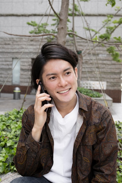 Free photo japanese man spending time outdoors alone