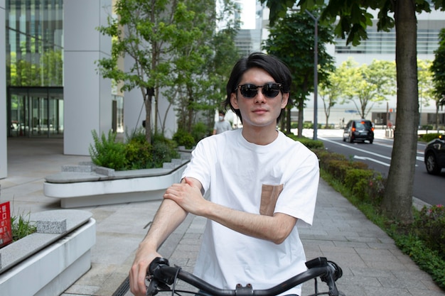 Free photo japanese man spending time outdoors alone