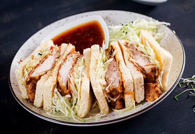 japanese sandwich with breaded pork chop, cabbage and tonkatsu sauce