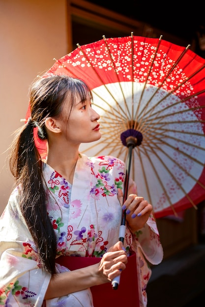 Free photo japanese wagasa umbrella help by young woman