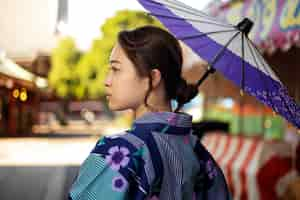 Free photo japanese wagasa umbrella help by young woman