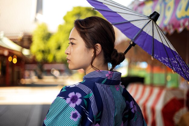 젊은 여성의 일본 와가사 우산 도움