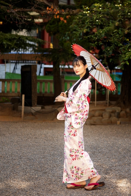 Free photo japanese wagasa umbrella help by young woman