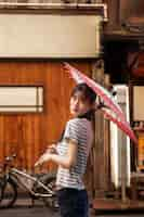 Free photo japanese wagasa umbrella help by young woman