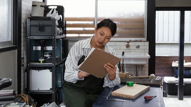 Free photo japanese woman holding clipboard medium shot