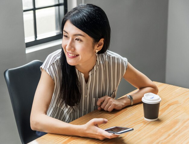 Japanese woman playing on her phone