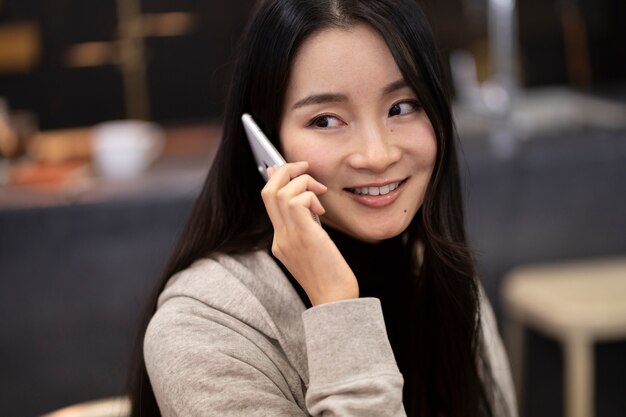 Japanese woman talking on her smartphone