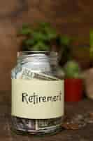 Free photo jar filled with money and retirement label