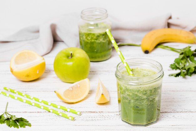 Jar of healthy smoothie with apple and lemon slices