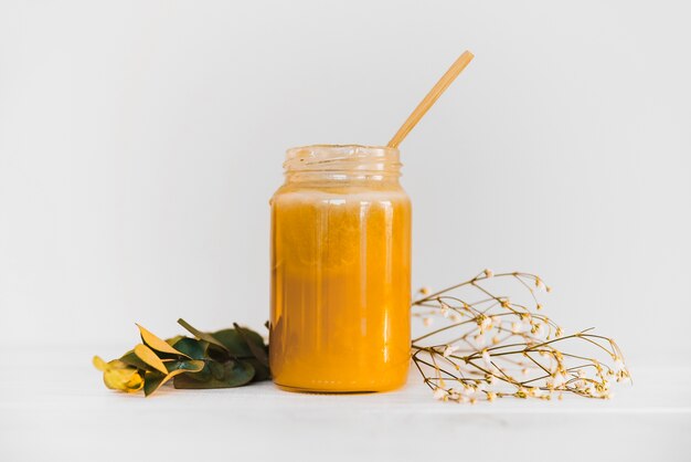 Jar of lemon curd on white background