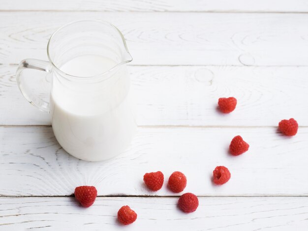 Jar of milk and raspberries