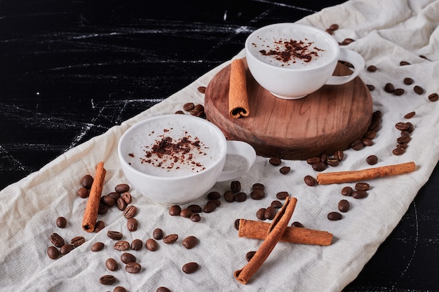 Jar of milk with coffee powder and beans.