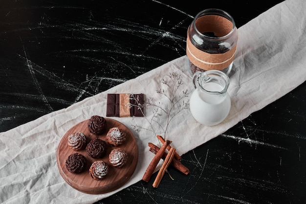 Jar of milk with coffee powder and pralines.