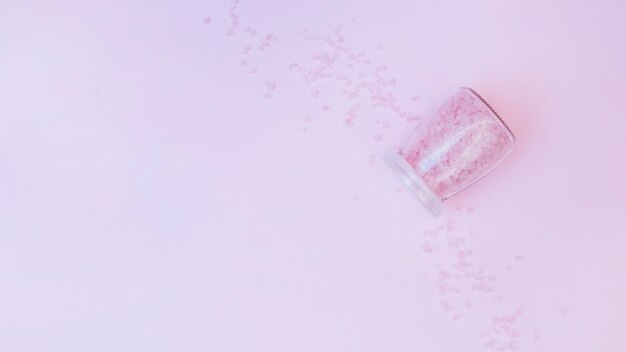 Jar of salt on purple background