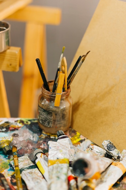 Jar with brushes on palette