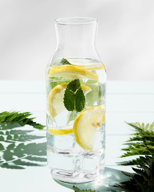 Jar with citrus fresh drink on desk