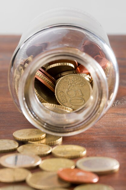 Jar with coins on table
