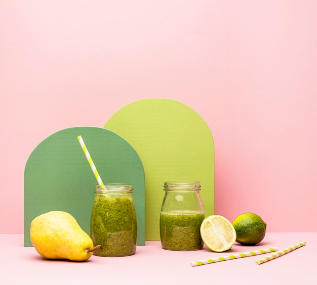 Jar with fresh smoothie of pear and lime on table