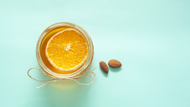 Jar with lemon slice and almonds