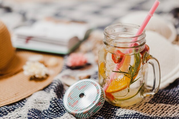jar with straw and fruits