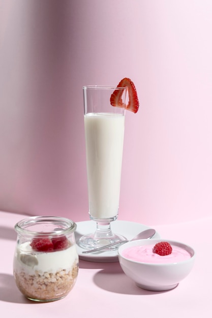 Jar with yougurt and fruit on table