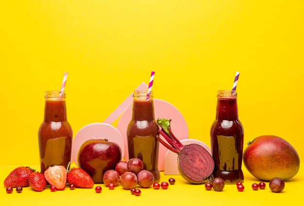 Jars collection with fresh smoothie on desk