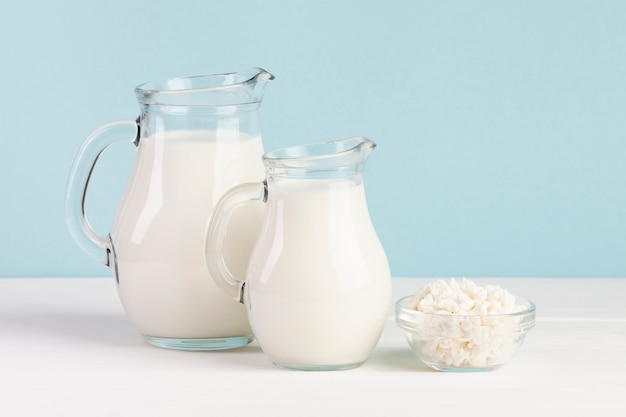 Free photo jars filled with milk on blue background