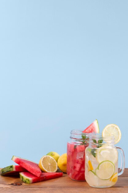 Jars with fresh drinks on table