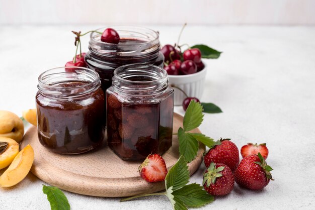 Jars with stewed strawberries and cherries