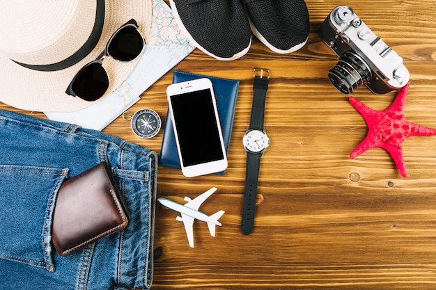 Jeans and wallet near tourist stuff