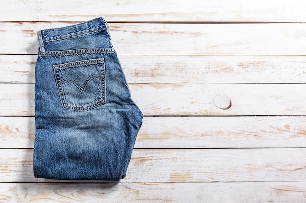 Jeans on wooden background