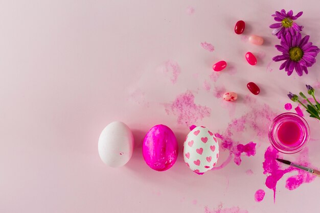 Jelly beans and flowers near eggs