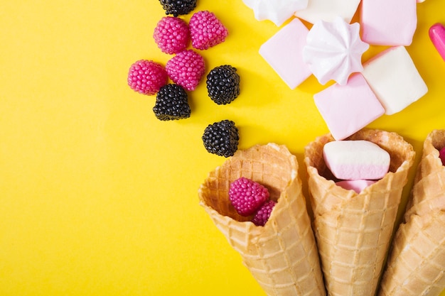 Jelly berries and marshmallows in waffle cones