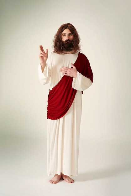 Free photo jesus showing the symbol of peace