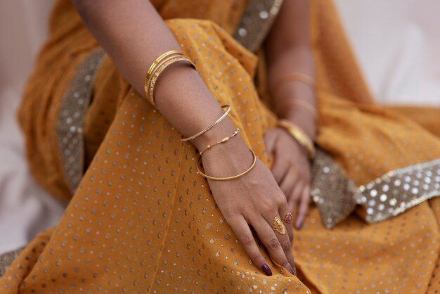 Jewel details on hands of woman wearing a sari dress