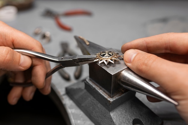 Free photo jeweler's hands making jewellery