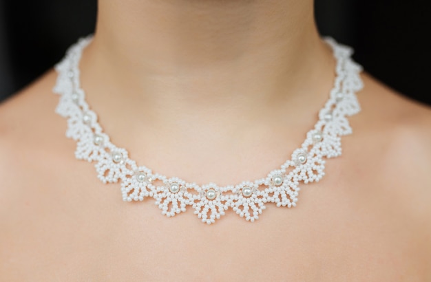 Jewelry concept. Closeup portrait of a wedding necklace on female neck