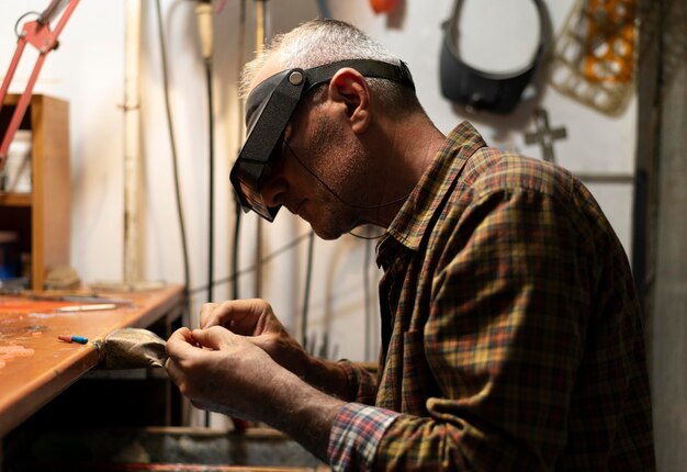 Jewelry maker working alone in the atelier