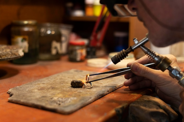 Free photo jewelry maker working alone in the atelier