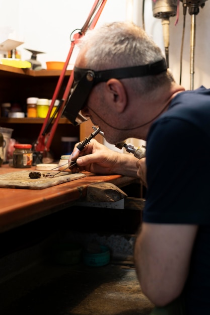 Free photo jewelry maker working alone in the atelier